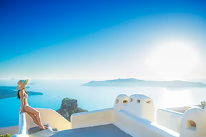 Women viewing islands in Santorini